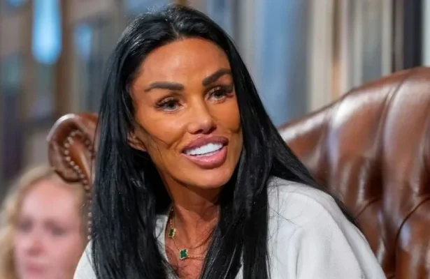 Katie Price puts up a bold front on stage while husband sits in jail