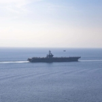 US Navy aircraft carrier transiting the Strait of Hormuz